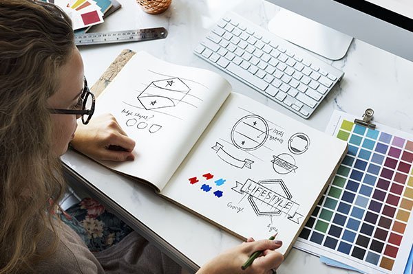 Woman sketching designs for a company rebranding