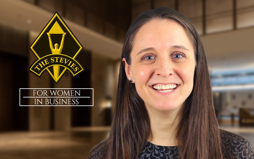 Logo of Gold The Stevies For Women in Business on a picture of Carolyn
