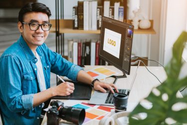 Male graphic designer working on logo design on computer