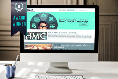 website on monitor with award winner banner
