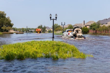 truck driving through hurricane flooded area