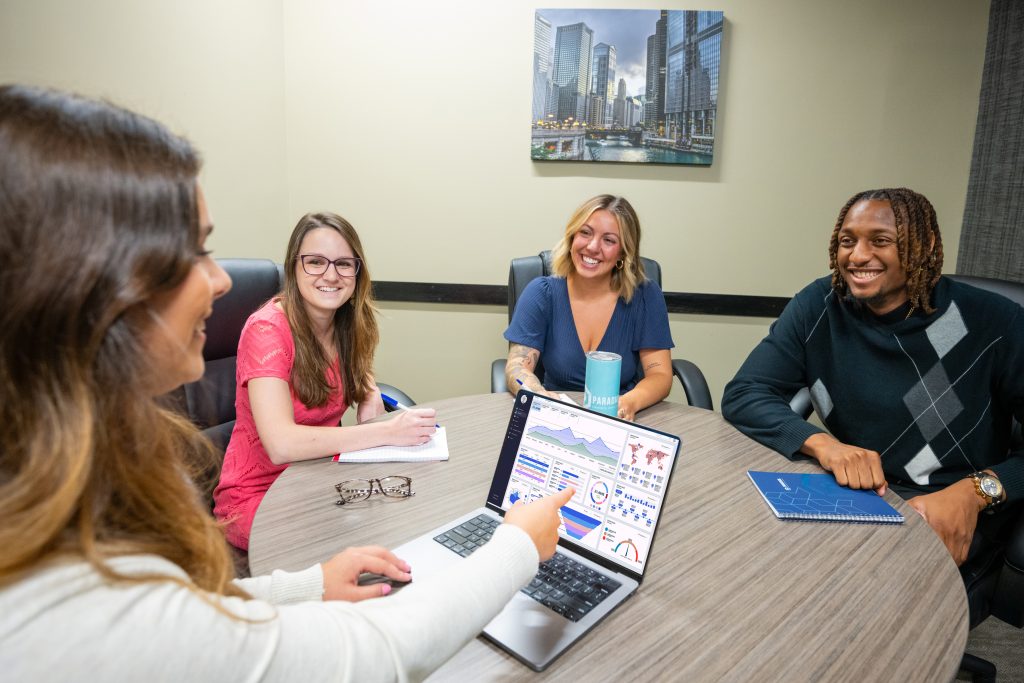 Marketing team analyzing lead scoring analytics on computer