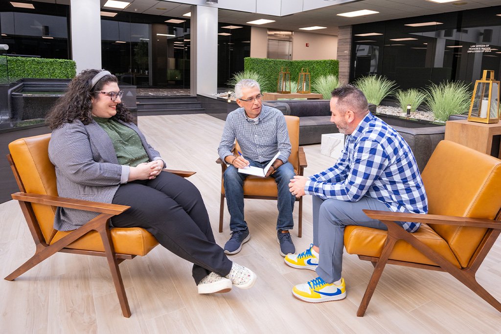 Three Paradigm team members meeting to discuss messaging strategies