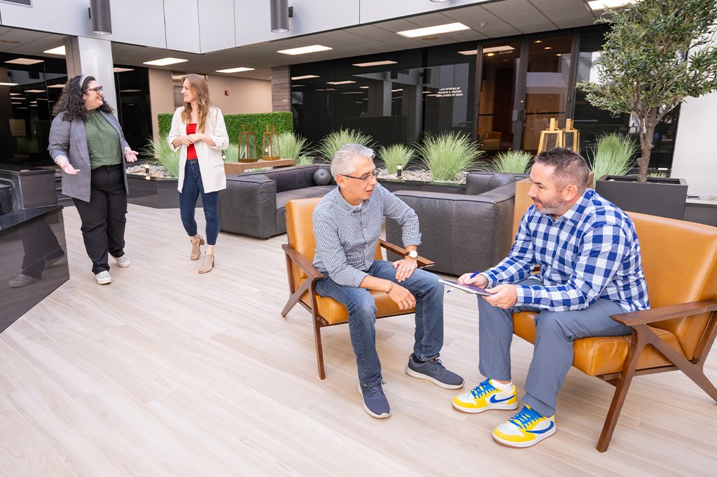 Paradigm's marketing, design and development team members having a discussion