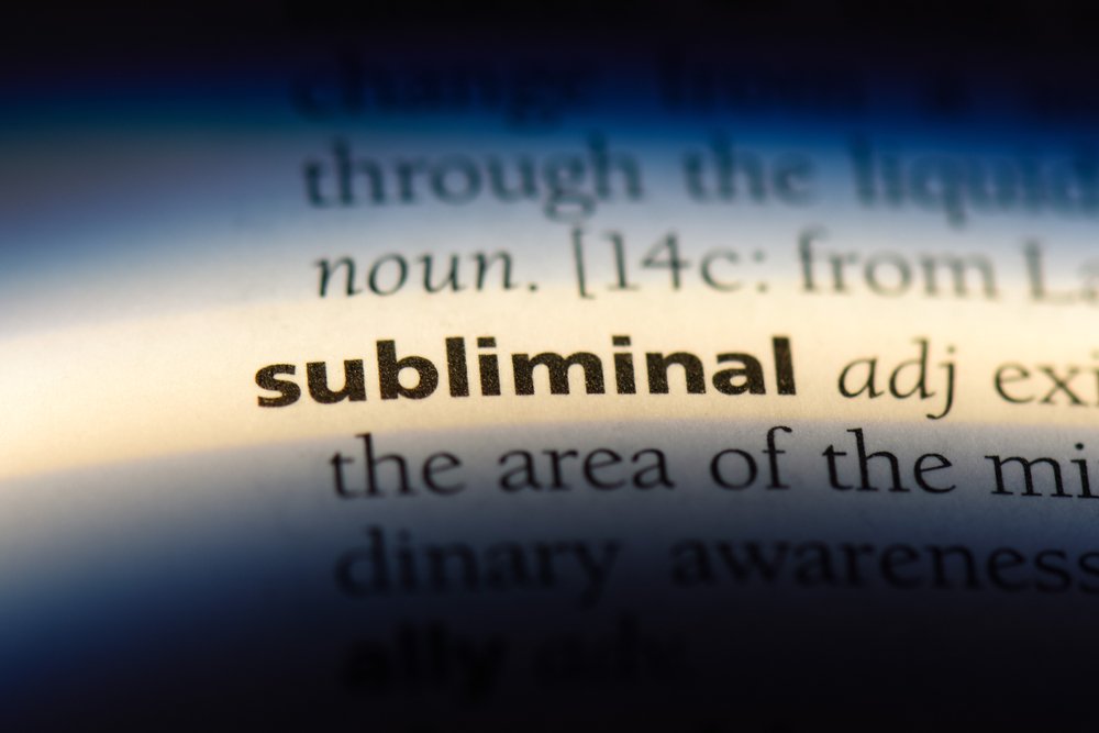 Bold subliminal word with its definition on a dictionary