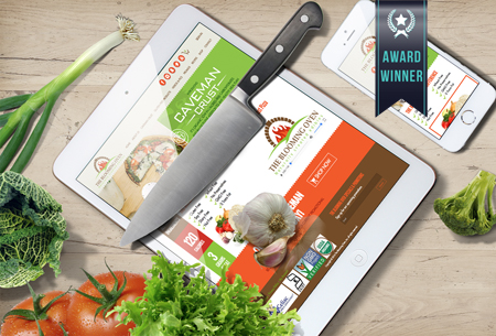 fresh vegetables next to tablet featuring Blooming Oven website