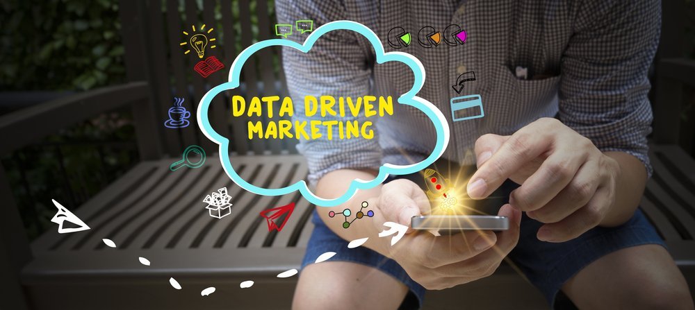 Data driven marketing concept with drawn icons on mobile phone