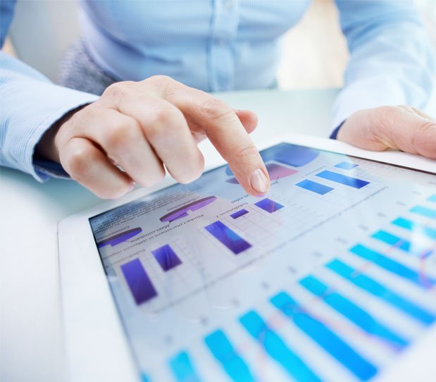 Woman pointing to charts on tablet