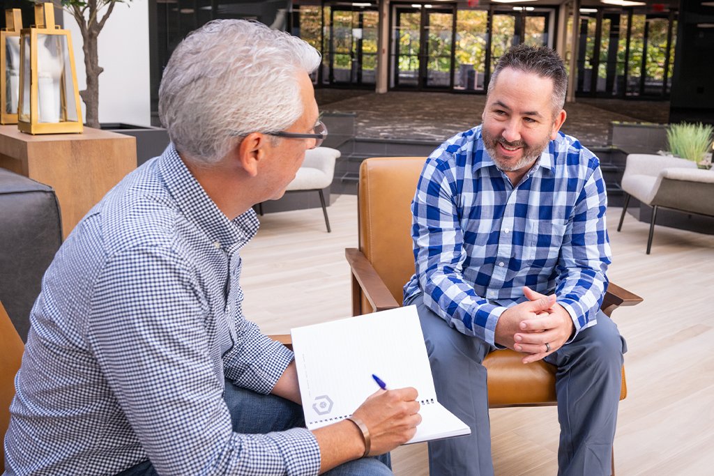 Two Paradigm team members discussing WordPress website design services