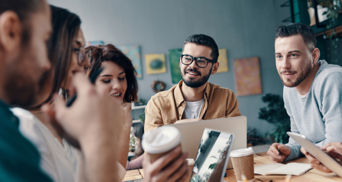 group of 5 people working together around a table