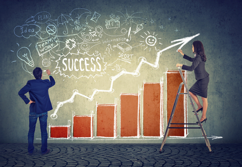 business man and woman charting marketing success